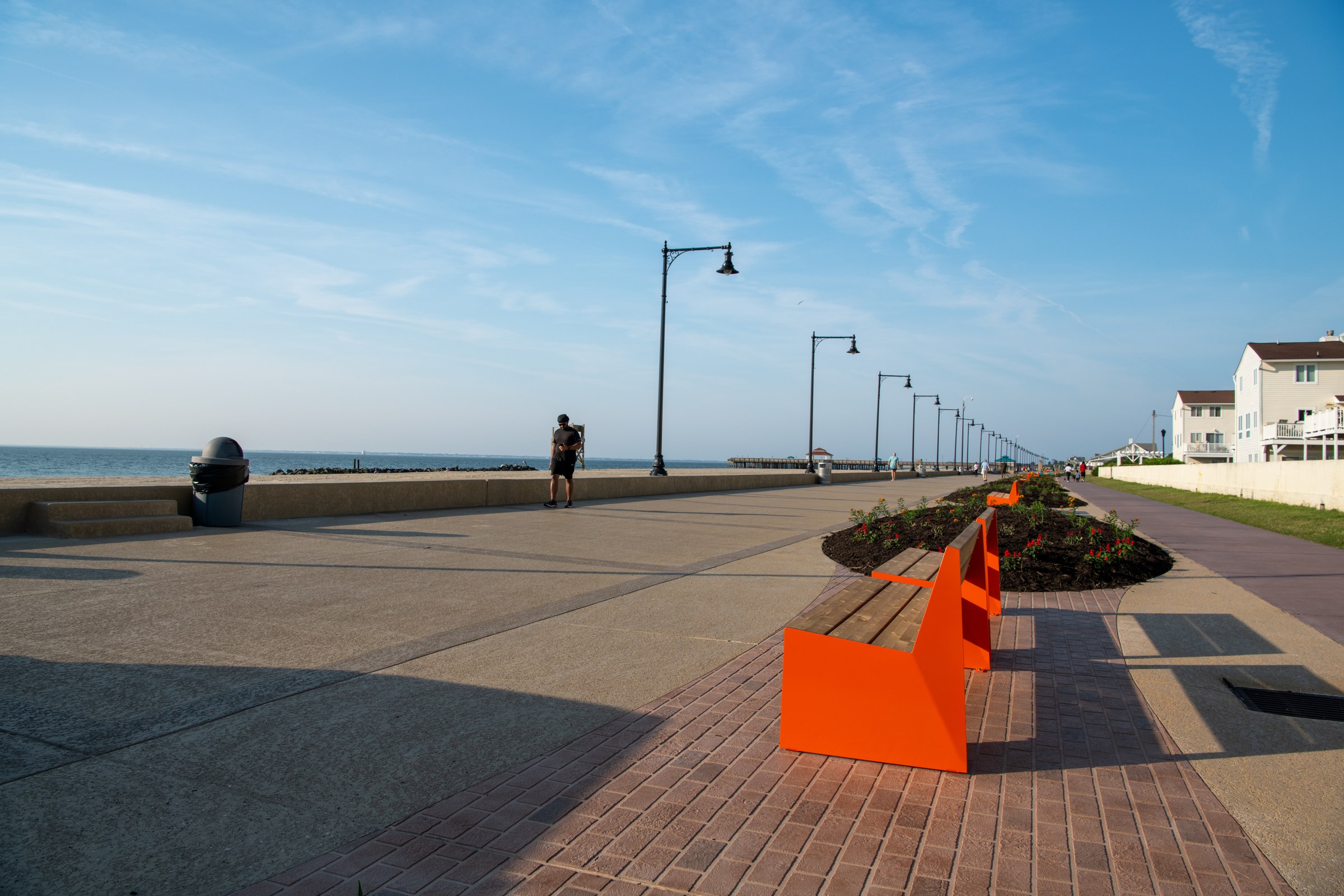 Finished decorative coatings on the boardwalk and seawall, with new benches beside existing pavers