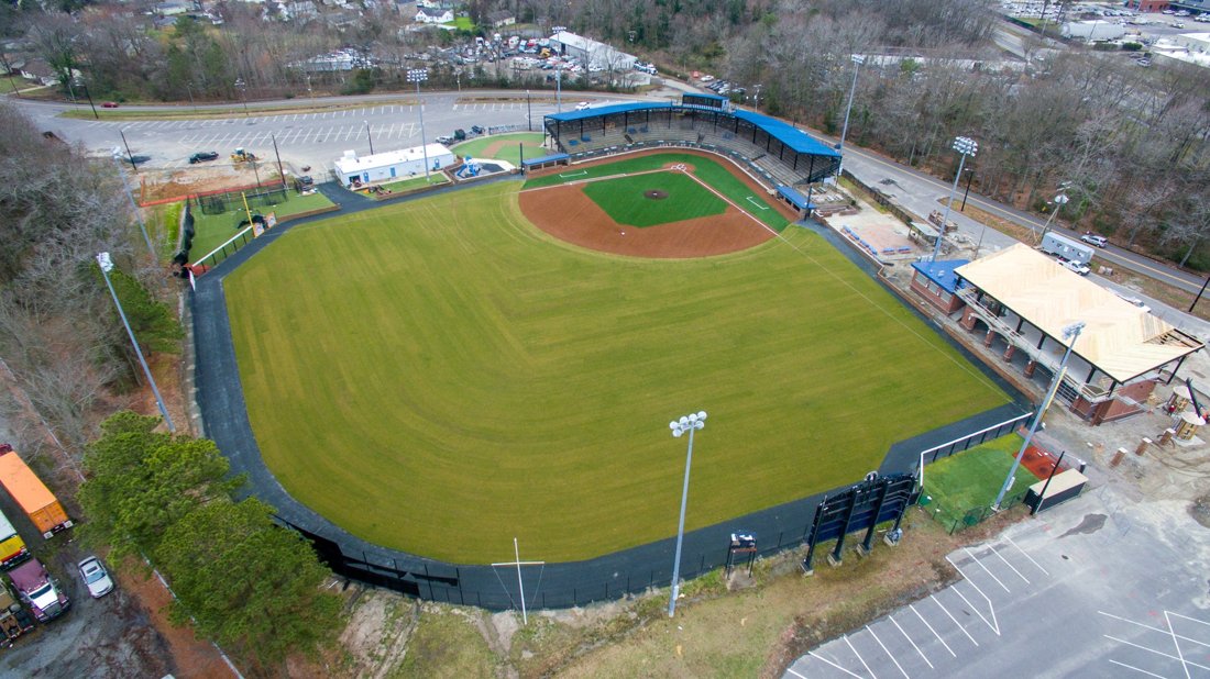 Aerial view of a baseball field with an artificial-turf infield and natural-grass outfield