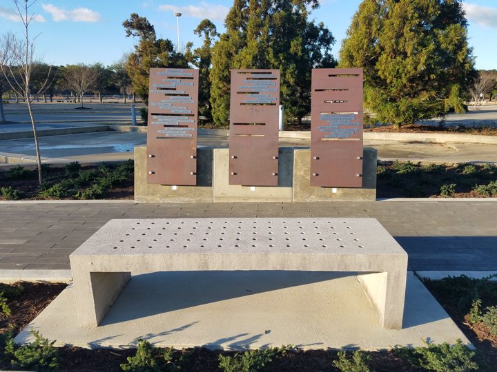 Memorial plaza with sculpted concrete walls and monuments