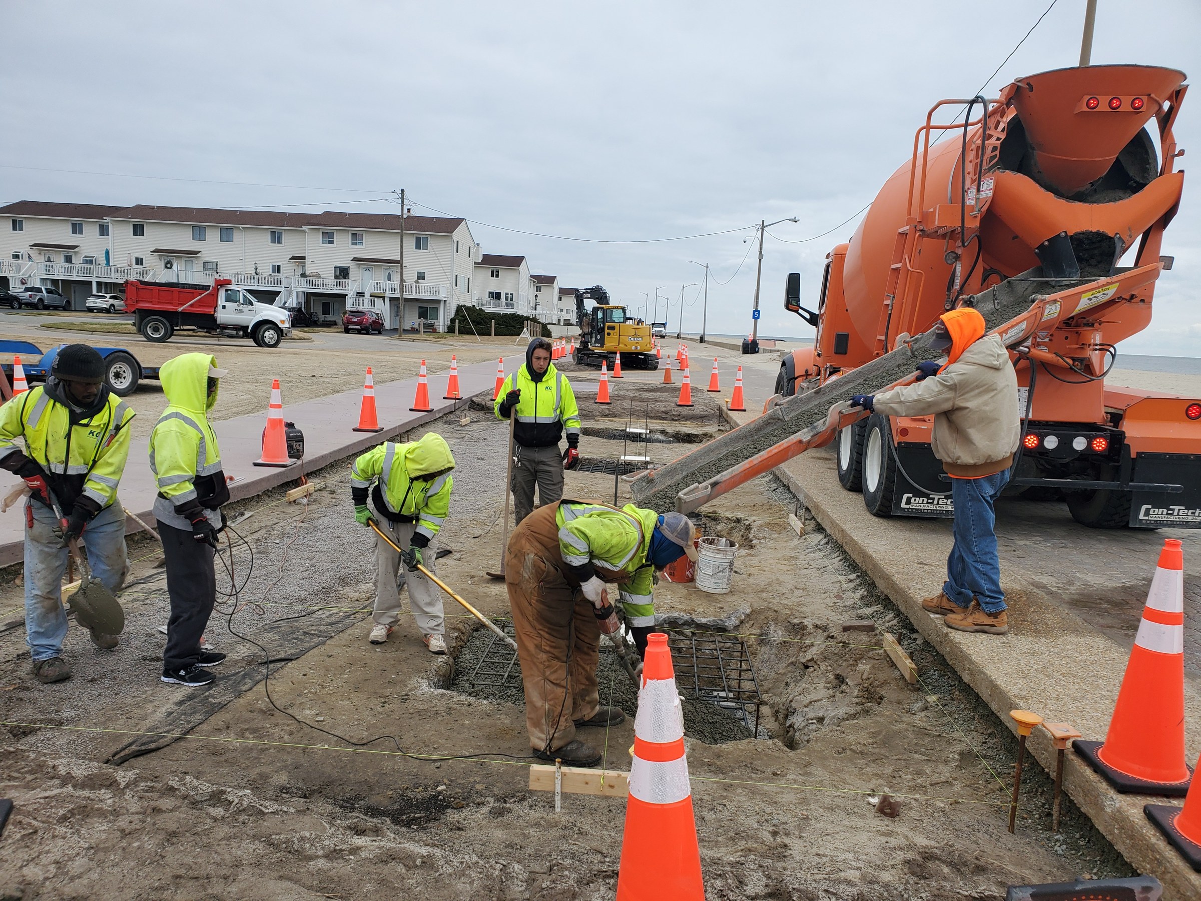 Crew placing concrete foundations for waterfront improvements
